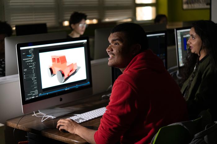 A graphic design student working at his computer.