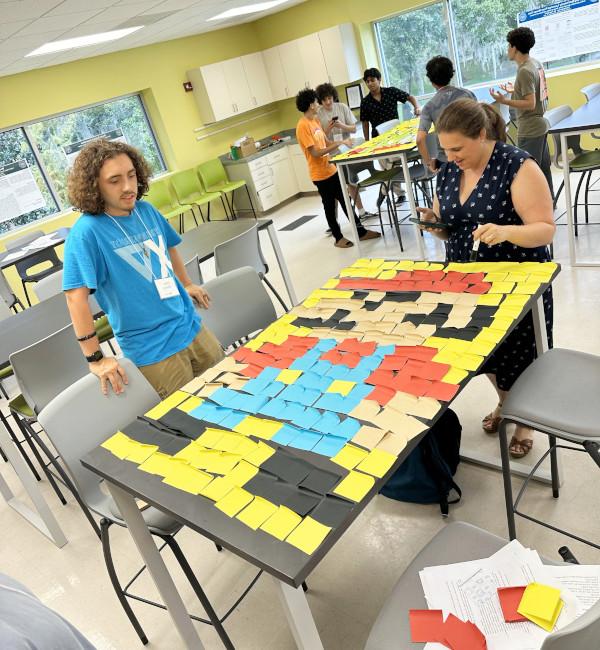 Two students working on building plastic robots. 